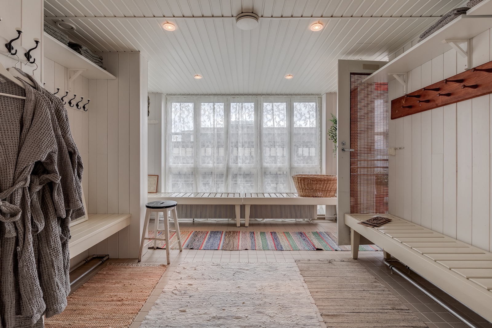 White changing room, bathrobes and rugs